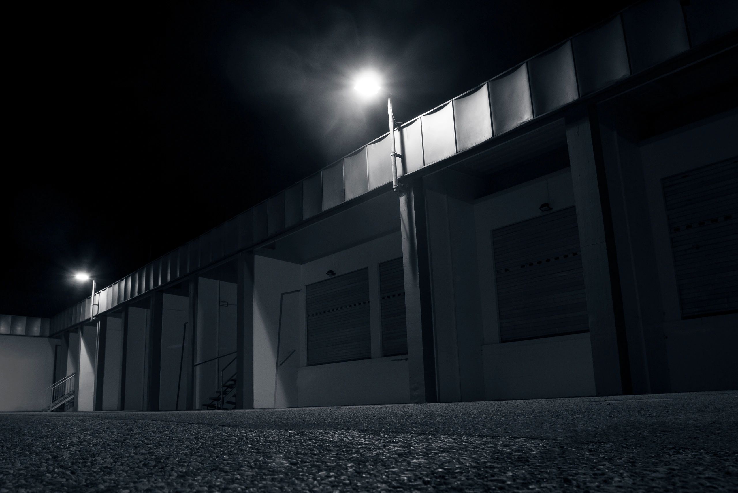 Dimly lit warehouse parking lot at night