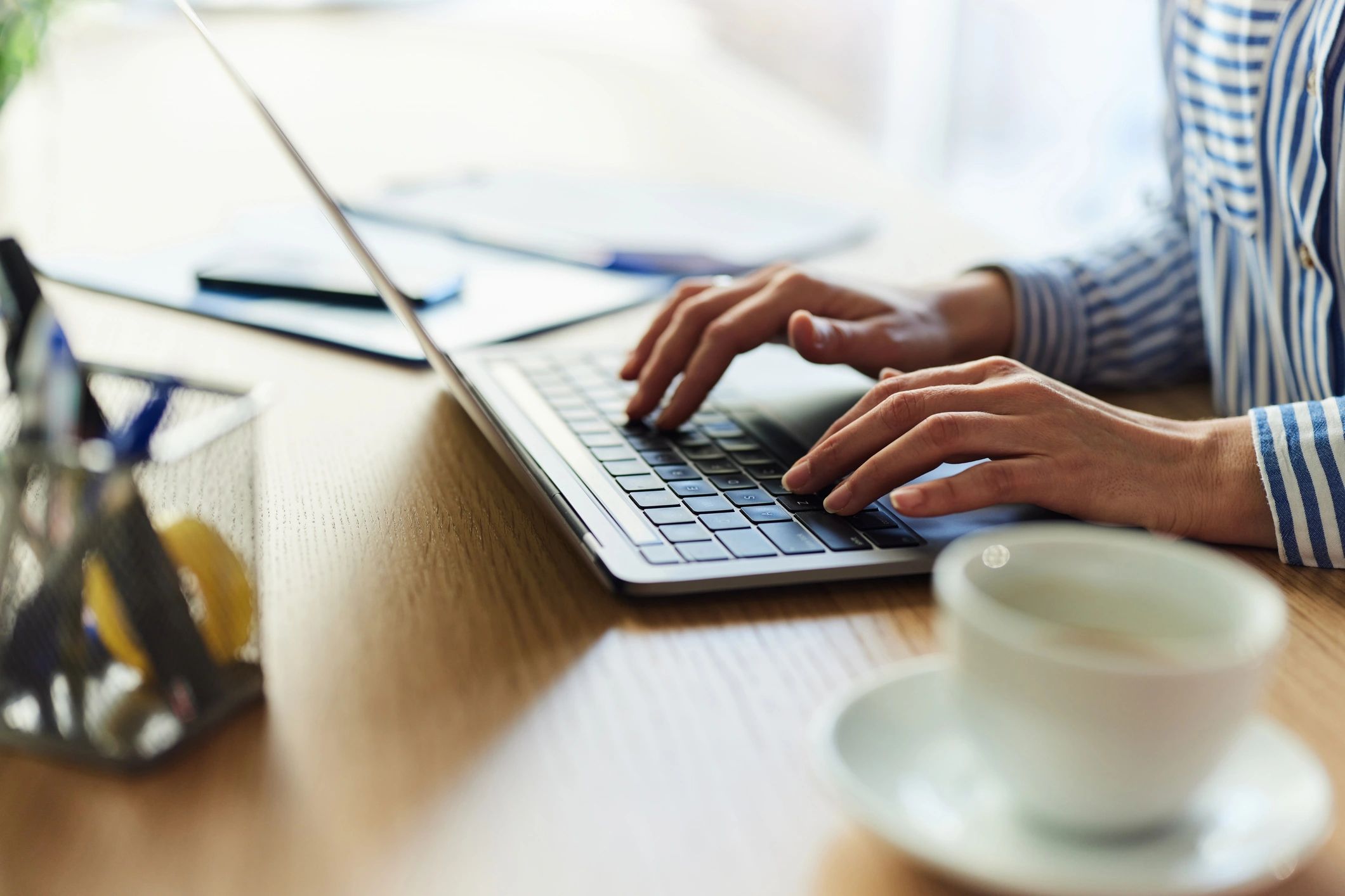 Person typing on a laptop at a desk